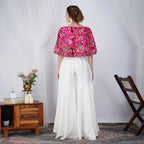 Back view of pink pearl-embroidered Zardosi cape with white skirt